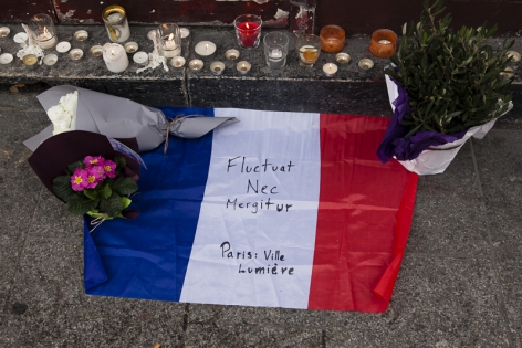  Candles and french flag on the crime scene in memory of the victims, outside the Carillon bar in Paris, France.